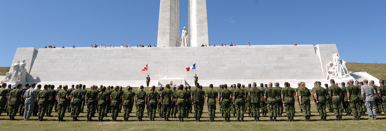 Vimy Ridge with Canadian Soldiers standing at attention 