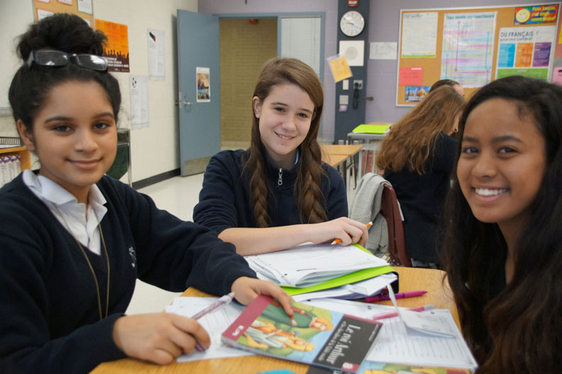 Three female students in a French classroom