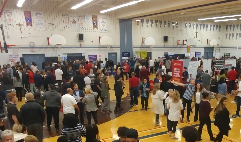 Gymnasium with students, parents, college/university/apprenticeship info booths