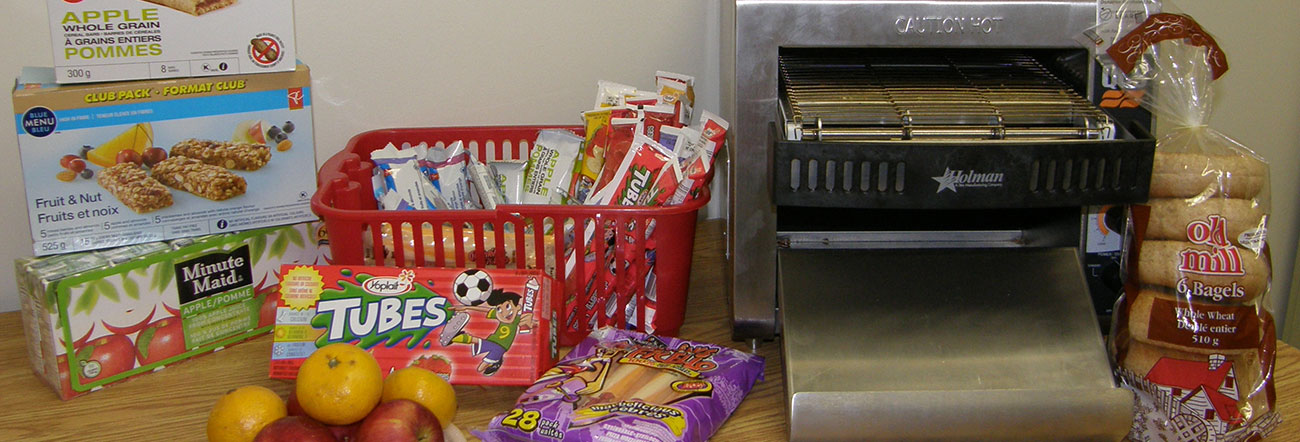 A variety of breakfast foods on a table with industrial toaster