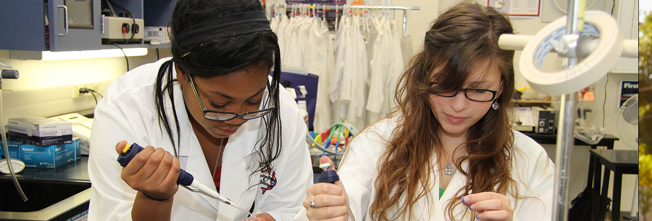 Two female students in a science lab